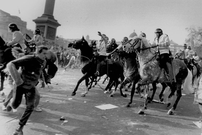 Mounted police charge Poll Tax demonstrators in Trafalgar Square, London, 1991